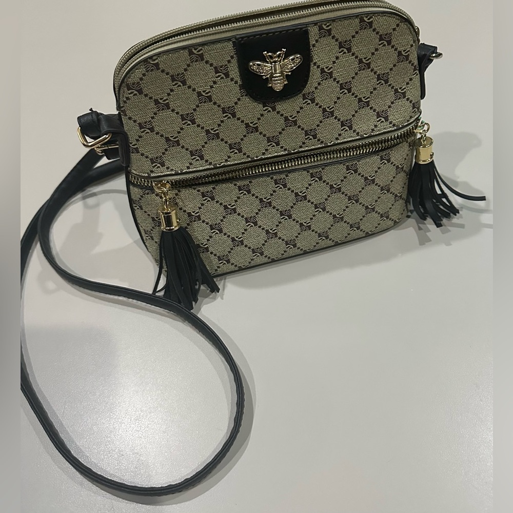 Bee Crossbody Bag Black & Cream with Striped Interior & Gold Hardware Accents.